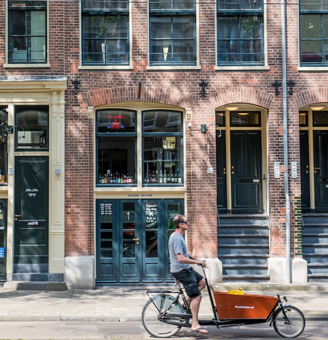 A man cycling in Amsterdam. 